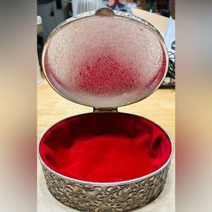 Vintage ornate silver with red velvet lining jewelry box.  Excellent condition.
